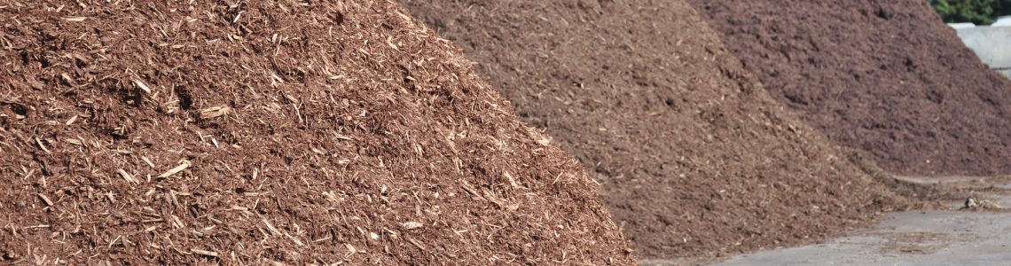 three different types of mulch offered for sale at a garden supply center