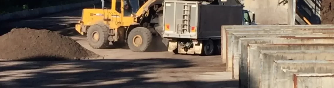 Truck being loaded by excavator